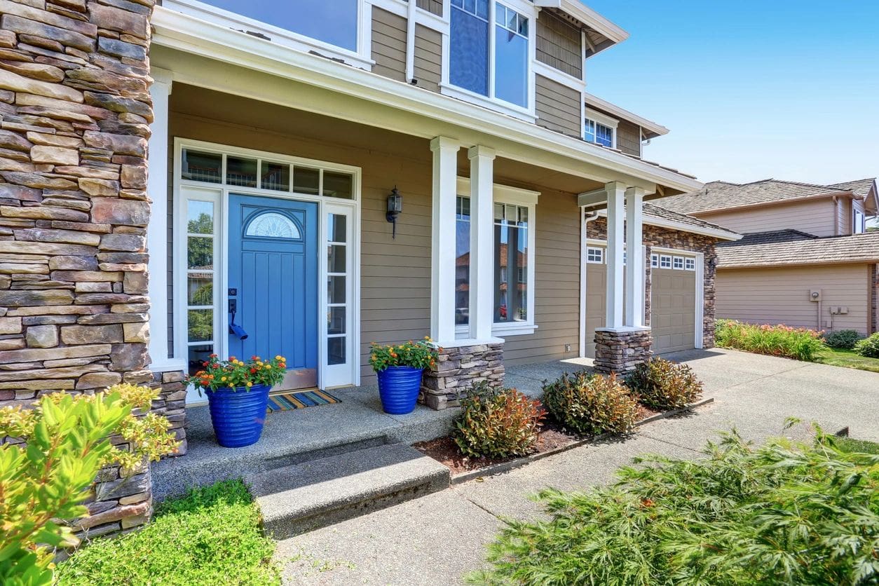 A house with blue doors and windows on the front.